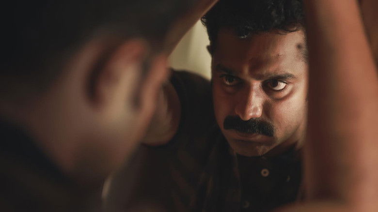 кадр из фильма കൂമൻ